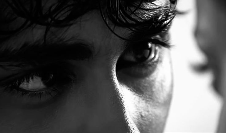 a close up of a person's face with dark hair