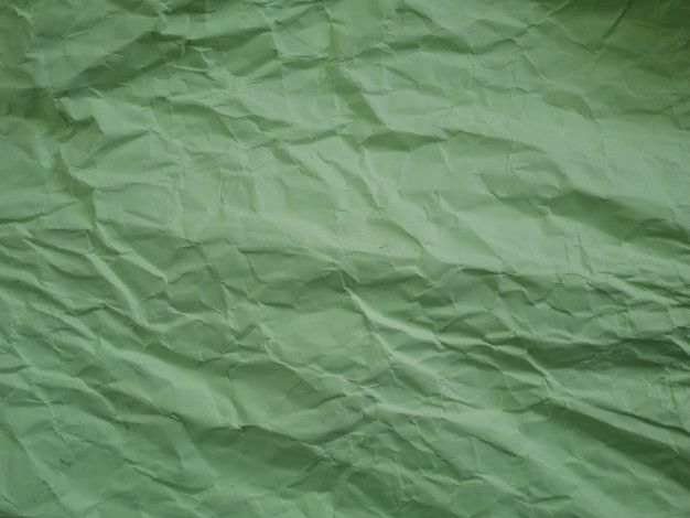 a green sheet of paper that has been wrinkled