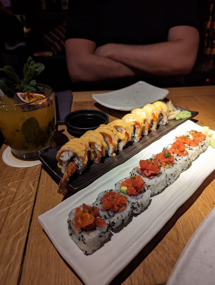 sushi is served on a long plate at a restaurant