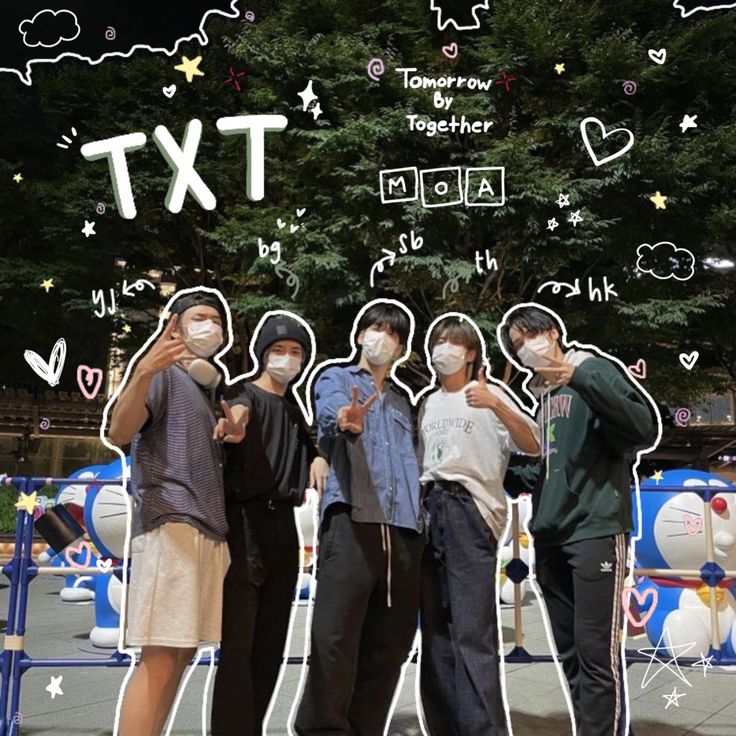 four people wearing face masks standing in front of a sign with the words txt on it