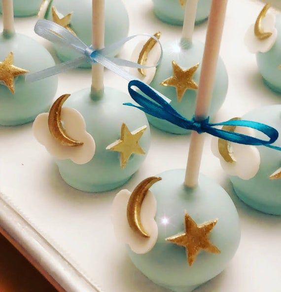 blue cake pops with gold stars and moon decorations