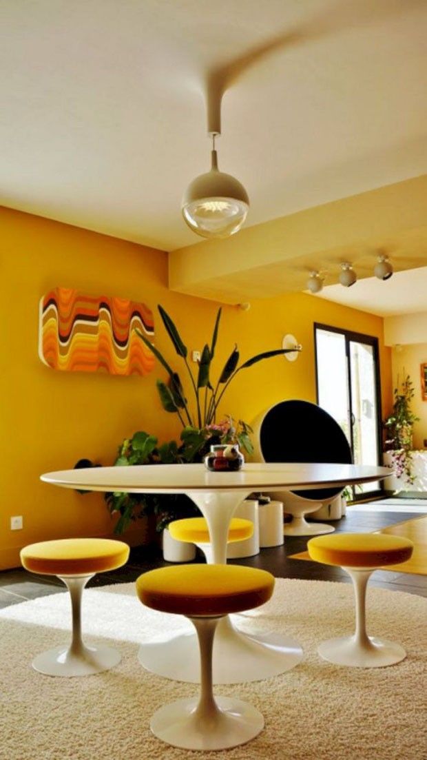 an image of a living room setting with yellow walls and white carpeted flooring