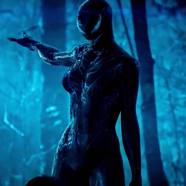 an alien woman standing in the woods with her arm out and glowing blue lights behind her