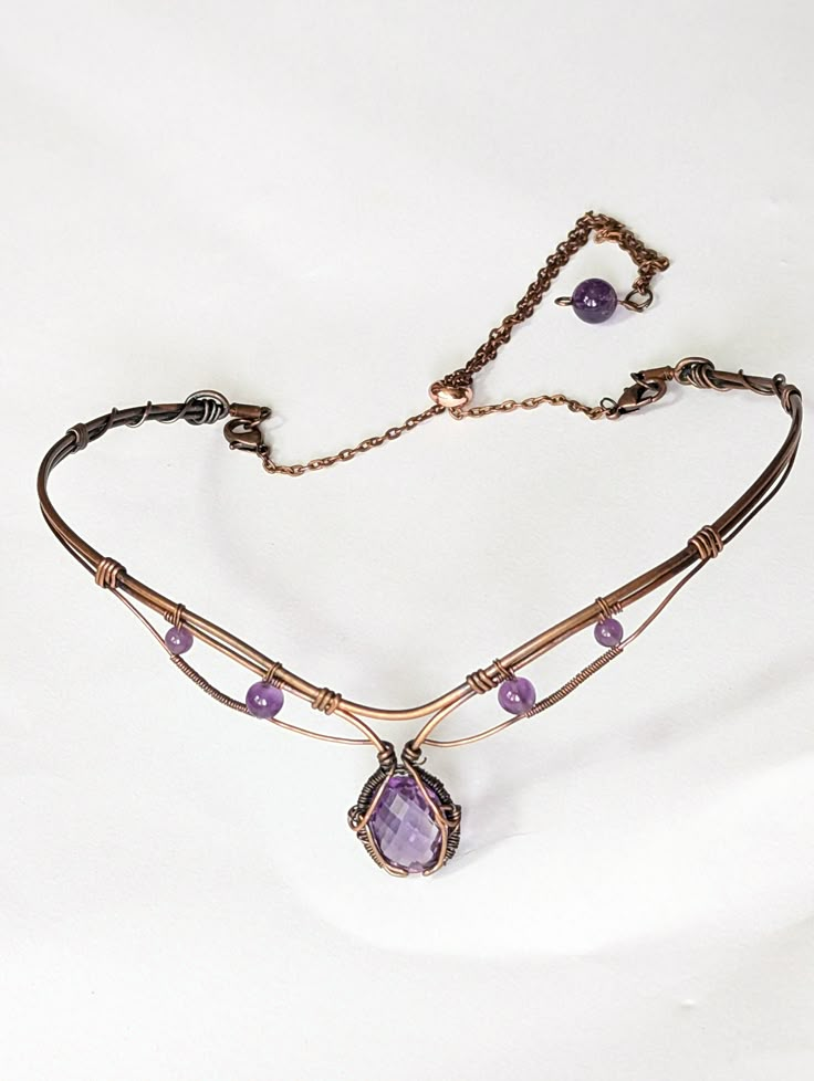 Enhance your look with this stunning 6ct Amethyst choker in copper! Handcrafted with quality materials, this choker features a beautiful Amethyst gemstone in the center, set in copper wire wrap that creates a beautiful and eye-catching design. The copper wire wrap is intricately detailed and flows gracefully around the gemstone, giving it an elegant feel. The choker fits comfortably around the neck and is lightweight enough to be worn all day. You'll be sure to make a bold statement with this un Wire Necklace Patterns, Wire Wrapped Tiara, Luxury Wire Wrapped Jewelry Gift, Wire Wrapped Clasps, Wire Necklace Designs, Wire Choker Necklace Diy, Copper Wire Necklace, Fantasy Wire Jewelry, Wire Wrap Choker