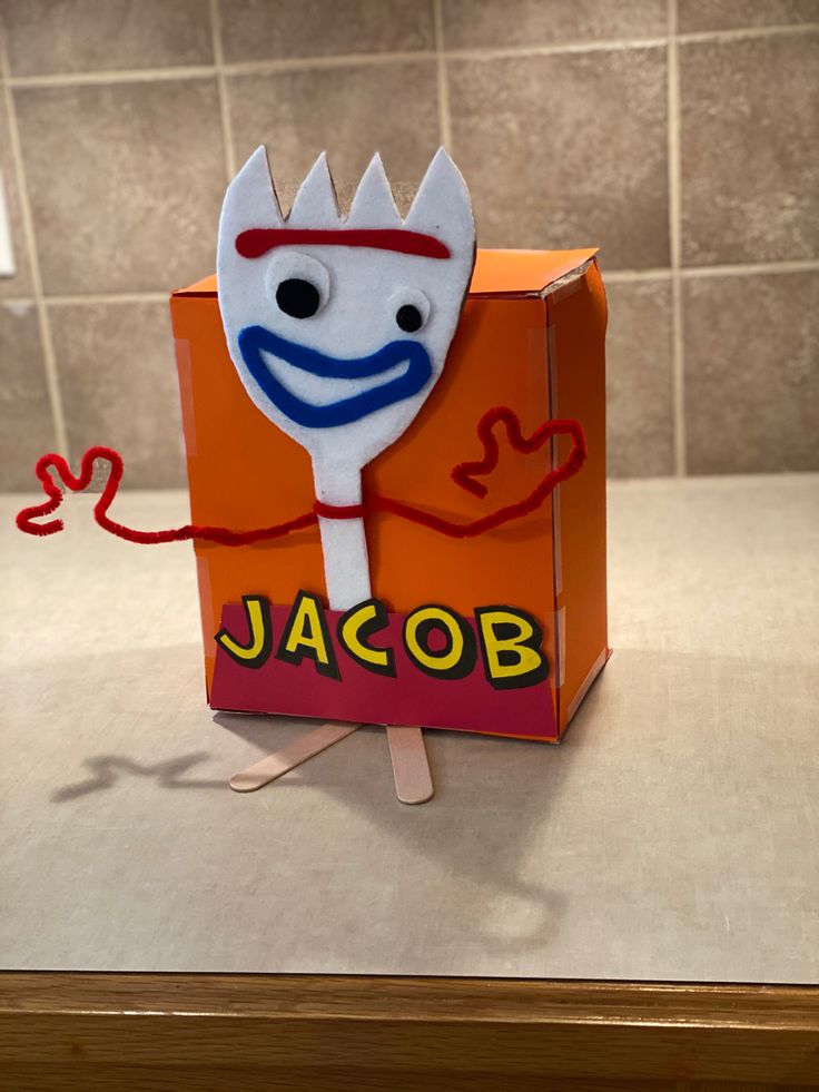 an orange box with a cartoon character sticking out of it