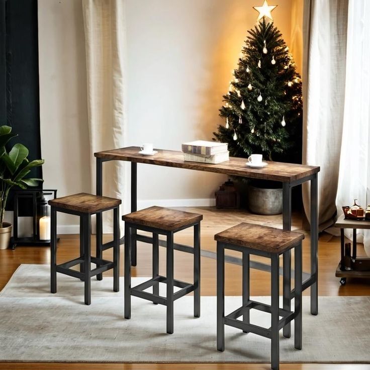 three stools and a table in front of a christmas tree