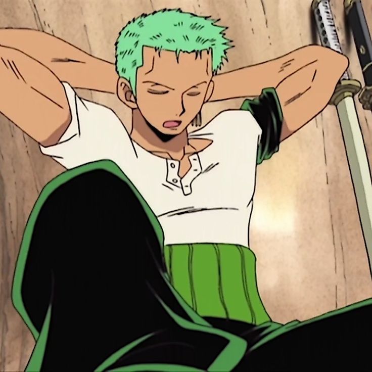 a man with green hair sitting on the floor next to a wall holding two swords