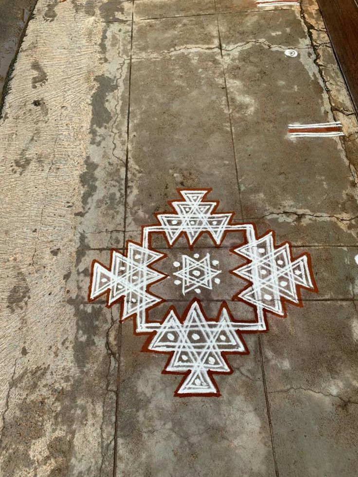 an intricately designed piece of artwork on the ground