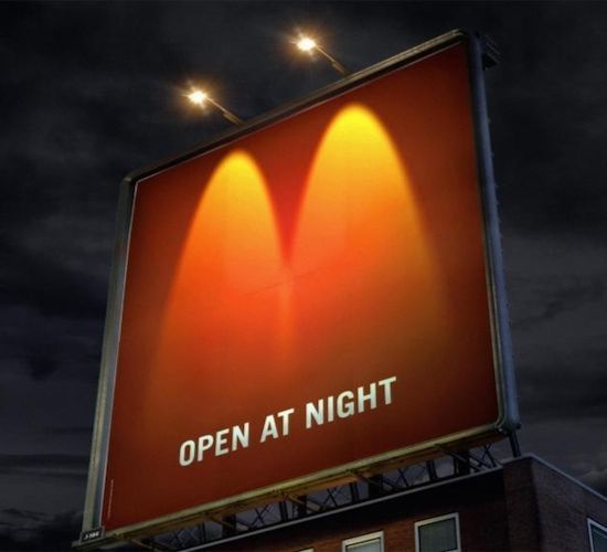 an open at night sign on top of a building