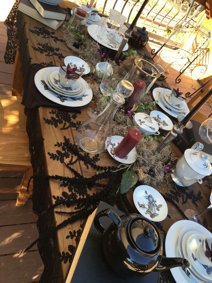 the table is set with dishes and cups