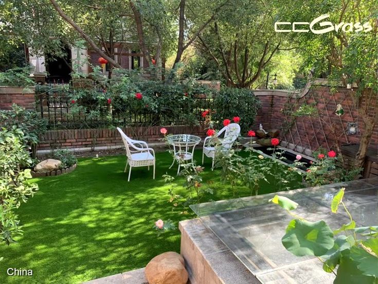 an outdoor garden with artificial grass and flowers