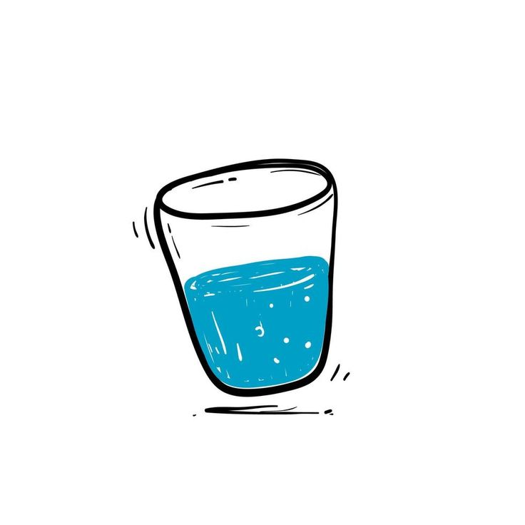 a glass filled with blue liquid sitting on top of a table