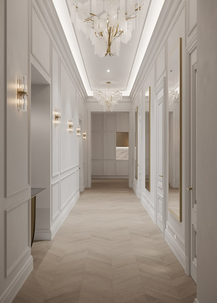 an empty hallway with chandeliers and white walls