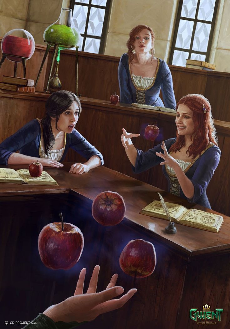 two women sitting at a table with apples in front of them and one woman holding out her hand