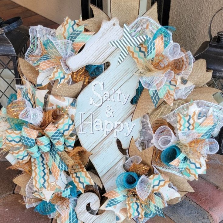 a wreath made out of burlocks and ribbon with the words sorry and happy on it