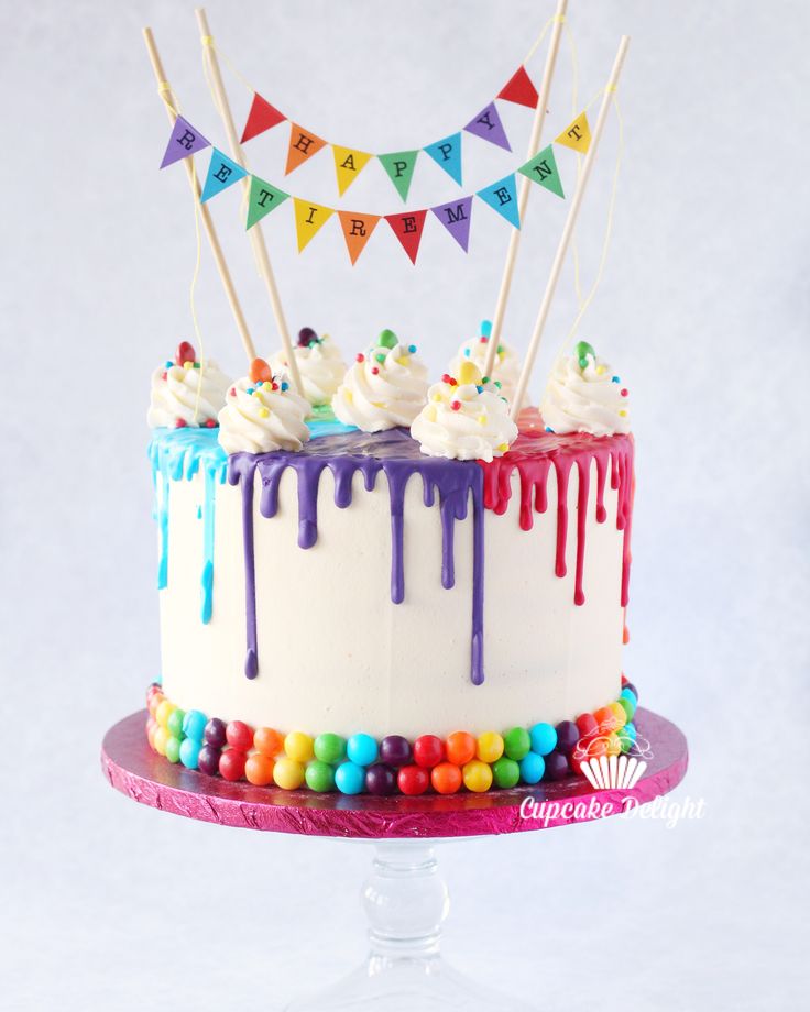 a birthday cake with white frosting and colorful decorations