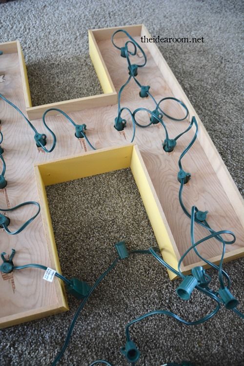 the letters h are made out of plywood and string wrapped around electrical plugs