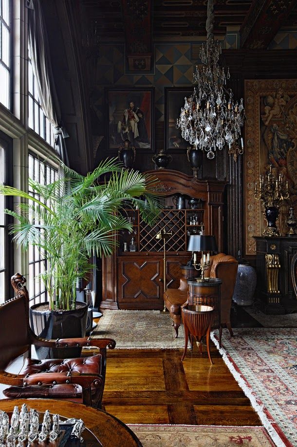 a living room filled with furniture and a chandelier