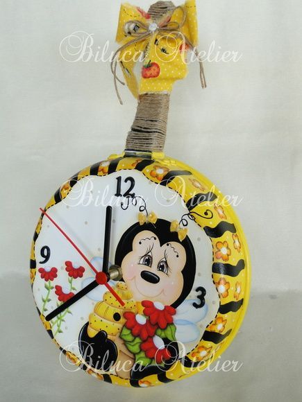 a yellow clock with a monkey on it's face is hanging from a wire