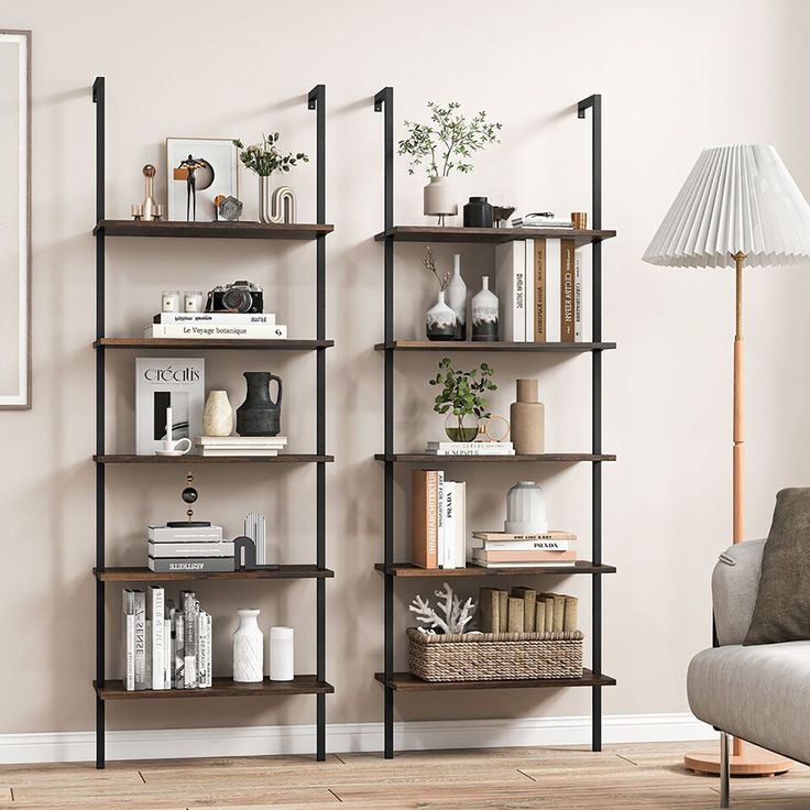 a living room filled with furniture and bookshelves next to a wall mounted lamp