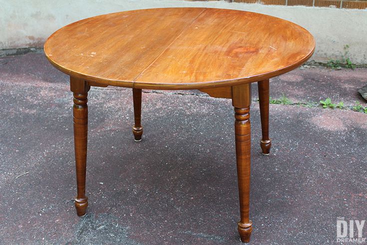 a wooden table sitting on top of a sidewalk