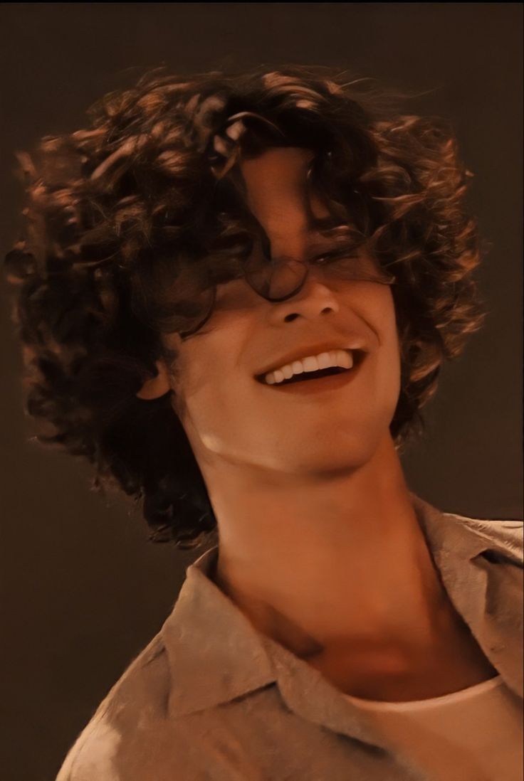 a close up of a person with curly hair