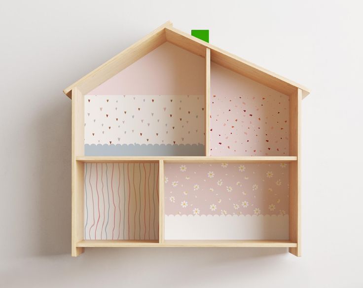 a doll house with pink and white walls, decorated with polka dot paper on the inside