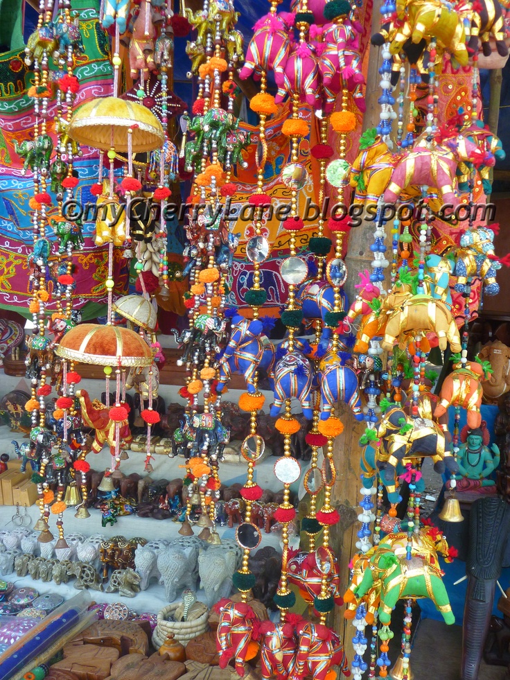 an assortment of colorful beads and umbrellas for sale