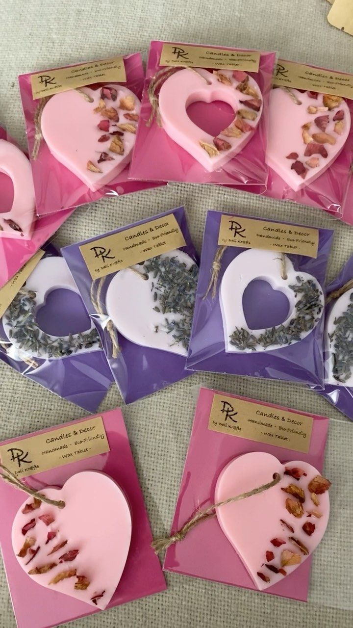 several heart shaped boxes with dried flowers in them on a table next to cards and envelopes