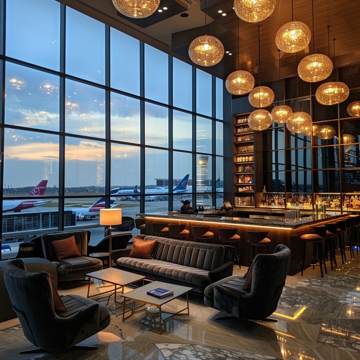 an airport lounge with large windows overlooking the tarmac