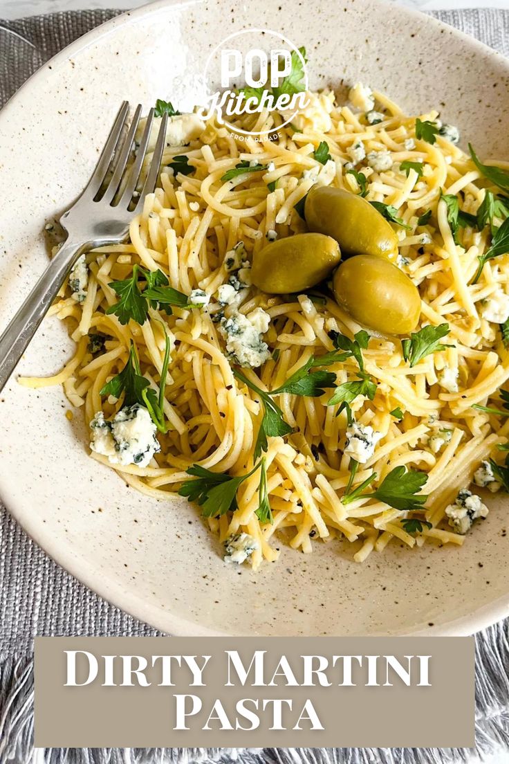 a white bowl filled with pasta and olives