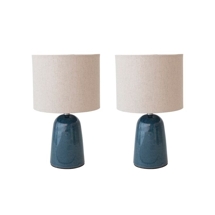 two blue ceramic lamps on a white background