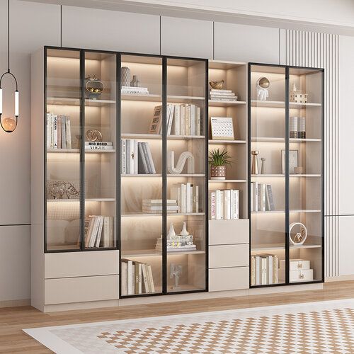 an empty room with some bookshelves and lights on the wall in front of it