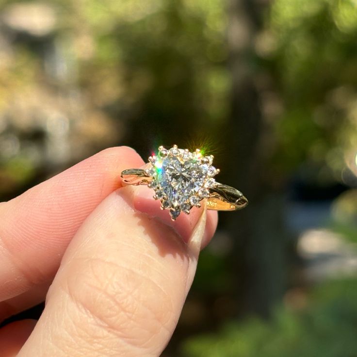 a woman's hand holding an engagement ring