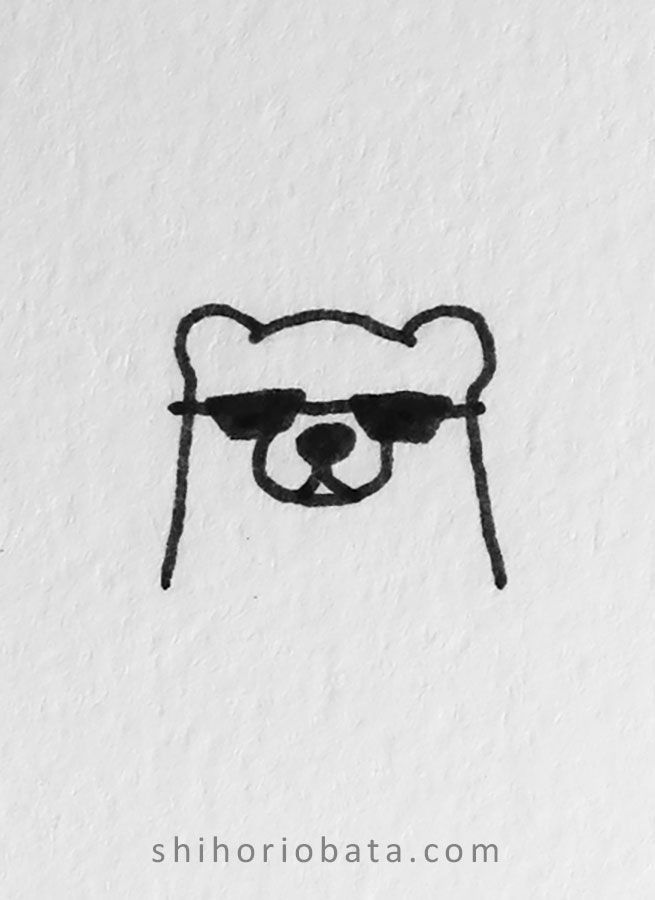 a black and white drawing of a bear with sunglasses on it's head is shown