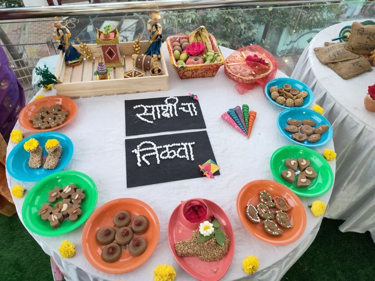 a table topped with lots of food on top of a white table cloth covered ground