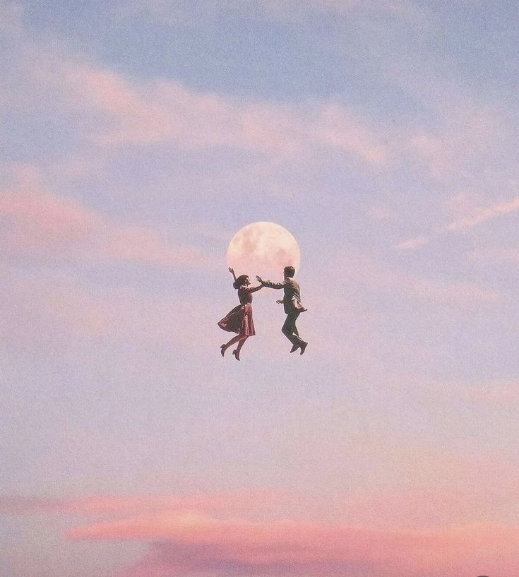 two people are flying in the air with a full moon above them and one person is reaching for the moon