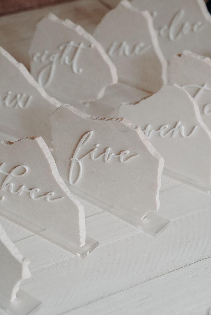 there are many pieces of paper that have been cut into small shapes with words on them