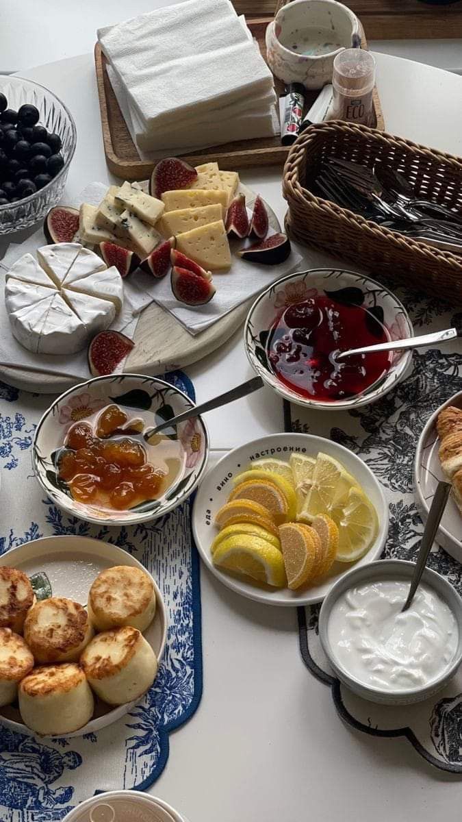 a table topped with plates and bowls filled with different types of food next to each other