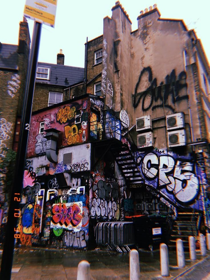 an old building with graffiti all over it