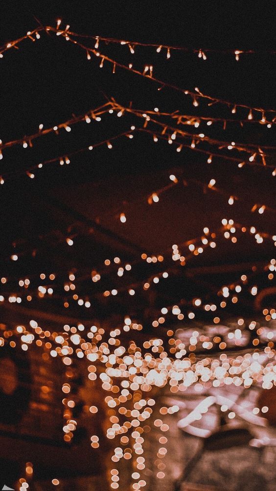 the lights are hanging from the ceiling in the dark room with no one around them