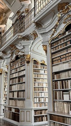 an old library with many bookshelves and ornate balconies on the walls