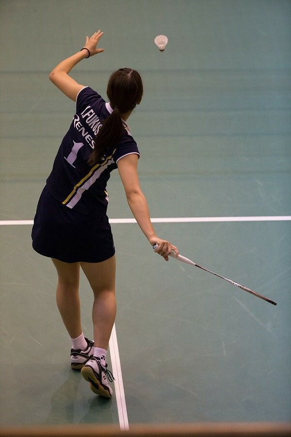 a woman hitting a tennis ball with a racquet