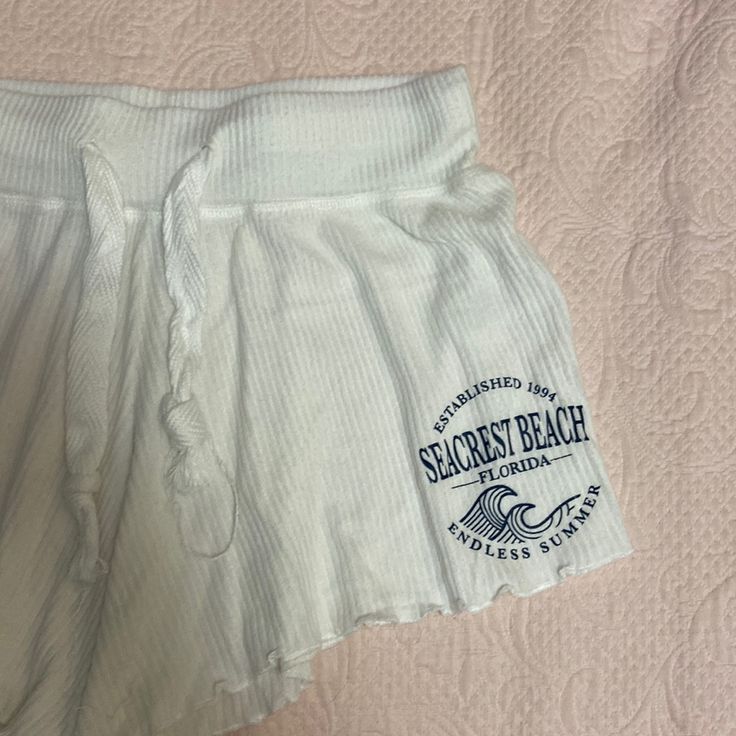 Size M - Never Worn White Flowy Shorts Cauliflower Hem Navy Logo “Seacrest Beach, Florida - Established 1994 - Endless Summer” Drawstring Tie Perfect As Day Shorts, Sleep Shorts, Or A Coverup! Bottoms With Built-in Shorts For Beach Party, Short Bottoms For Beach Party, Casual Bottoms With Built-in Shorts For Beach Party, Casual Stretch Beach Shorts, Casual Stretch Shorts For Beach, Beach Season Beachy Pajama Shorts For Loungewear, Stretch Beachwear Shorts For Beach Party, Beachy Cotton Shorts For Beach Party, Beachy Pajama Shorts For Loungewear During Beach Season