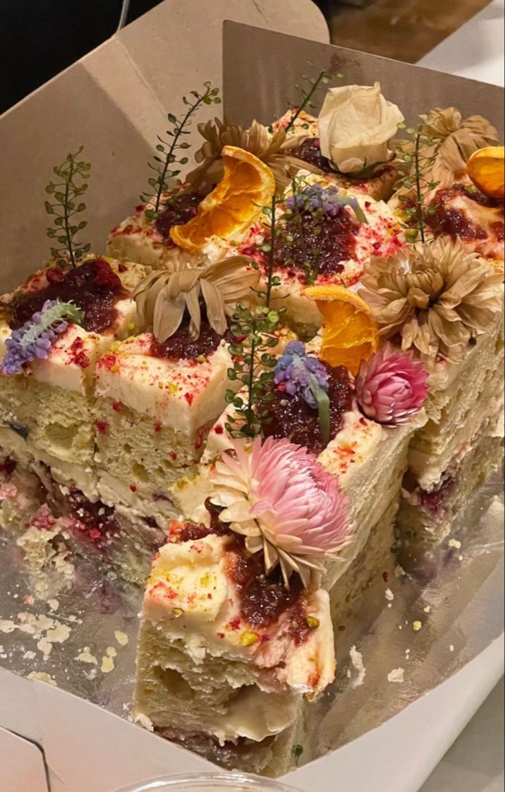 a piece of cake with flowers on it in a box