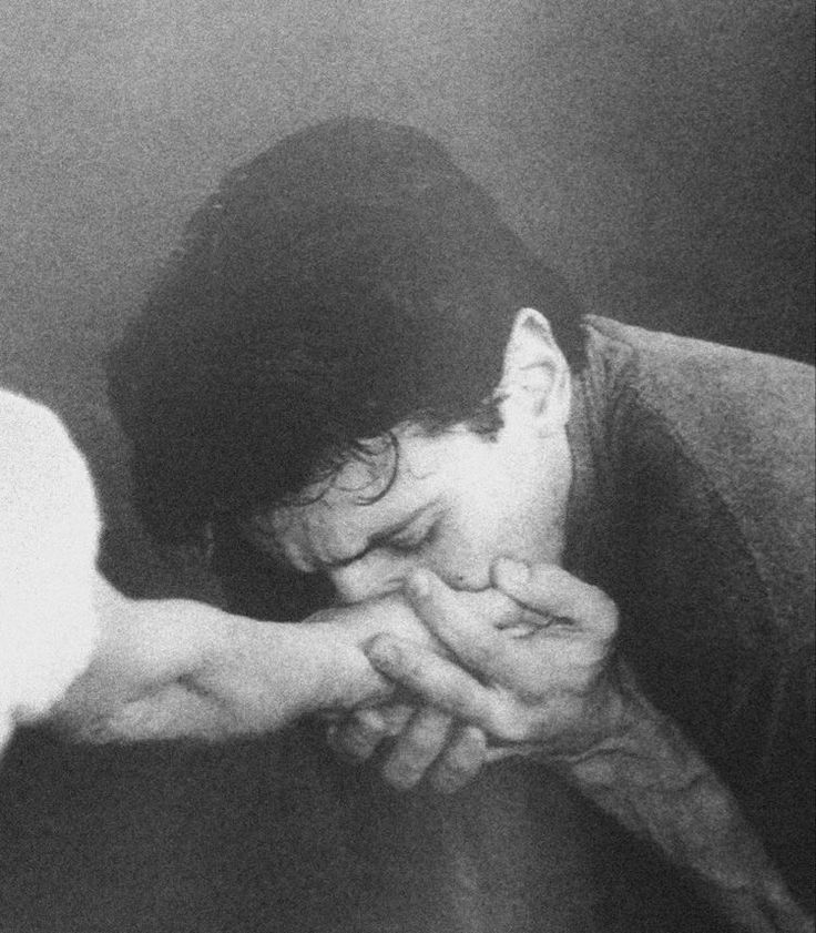 a black and white photo of a person holding a cat