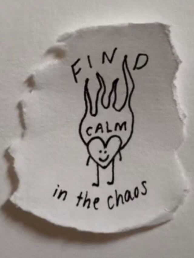 a torn piece of paper that says find calm in the chaos