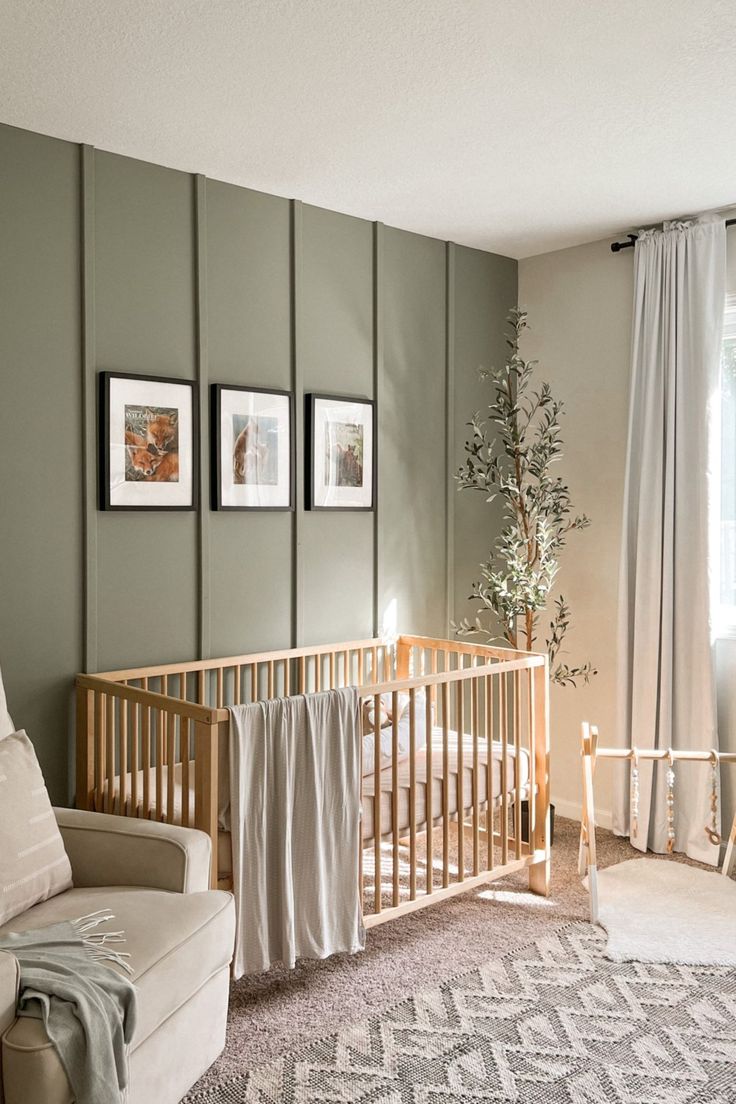 a baby's room with a crib, chair and pictures on the wall