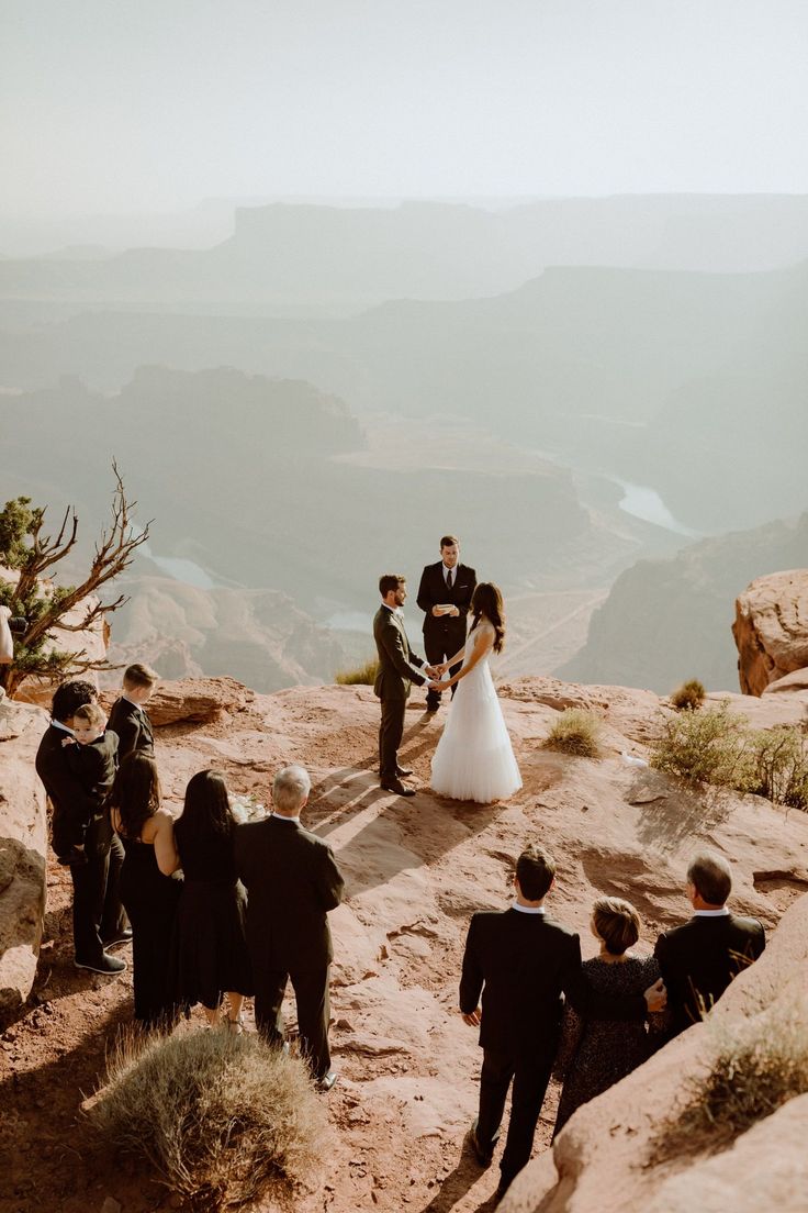 a couple getting married on top of a mountain