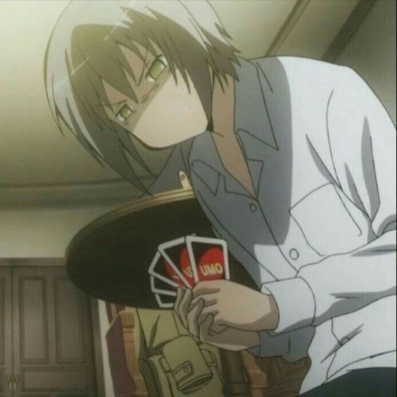 an anime character holding cards in his hand and looking down at the camera man's face